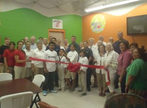 Ribbon cutting for The Ship Store, which was named in honor of the United Stated Coast Guard volunteers for all the service, mentoring and coaching that they provided over the past year, took place Wednesday, May 18. Pictured are members of the USCG under the leadership of Lt. Mickey Lalor, members of the Laguna Madre Boys and Girls Club, Board of Directors and staff and the Chamber of Commerce Ambassadors.  (Photo by Lauren Laughlin)