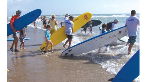 Seen here is a group surfing for the Interna¬tional Surfing Day Children’s Surf Clinic on SPI on June 20.
