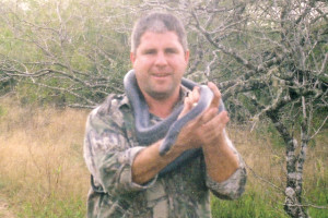 Matt Thornton, an avid outdoorsman, is pictured handling a snake during one of his many hunting excursions. (File photo)