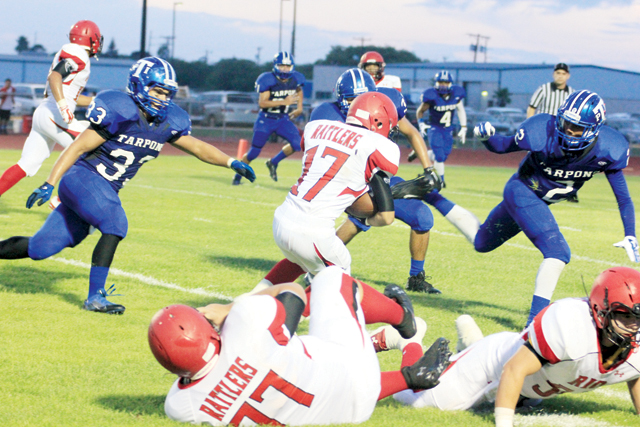 (Staff photo by Ray Quiroga) The Port Isabel Tarpon “Seawall” defense is seen swarming a Rio Grande City ballcarrier during Friday night’s non-district title at Tarpon Stadium.