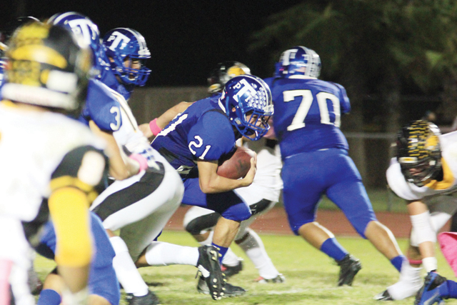 (Staff photo by Ray Quiroga) Port Isabel Tarpons running back JJ Gonzalez is shown fighting for running room against a stingy Rio Hondo Bobcats defense on Friday, Oct. 17.