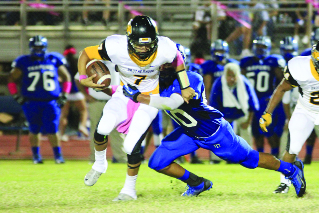 (Staff photo by Ray Quiroga) Rio Hondo Bobcats quarterback Eli Pitones is pictured breaking a tackle against a Port Isabel Tarpons defender on Friday at Tarpon Stadium.