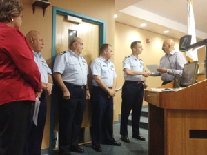 SPI Mayor Barry Patel presents Lt. Cmdr. William Bell with a proclamation welcoming him, on behalf of the City, as the new SPI Coast Guard Station commander. 