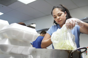 Nikki Soto prepares coleslaw as part of a meal program offered by the City of South Padre Island to its employees, as well as law enforcement, during Texas Week. (Staff photo by Dina Arévalo).